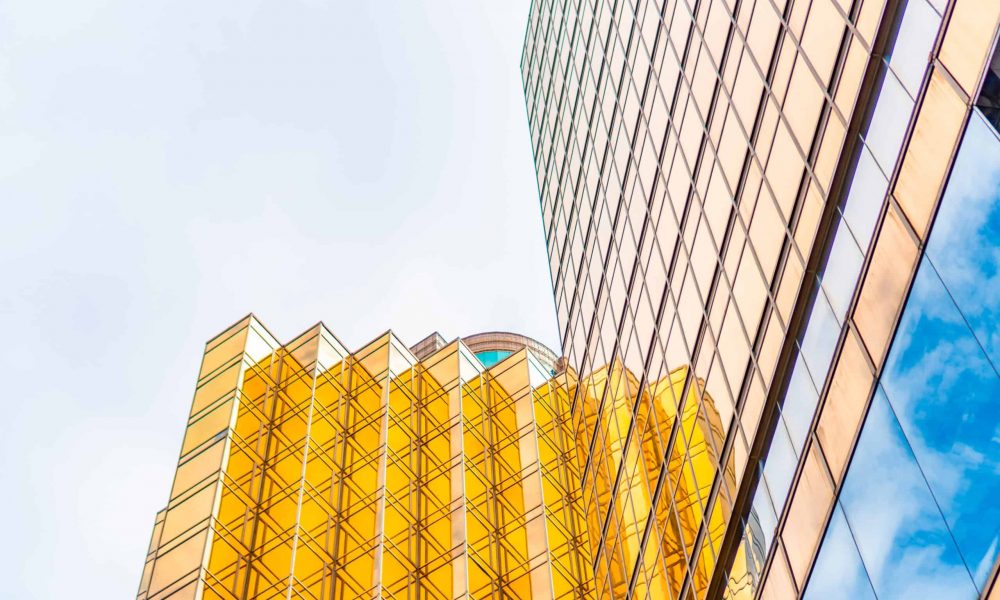 HONG KONG, CHINA - January, 2021 : Golden tall buildings and glass reflections in Hong Kong Island Business concepts of buildings and architecture