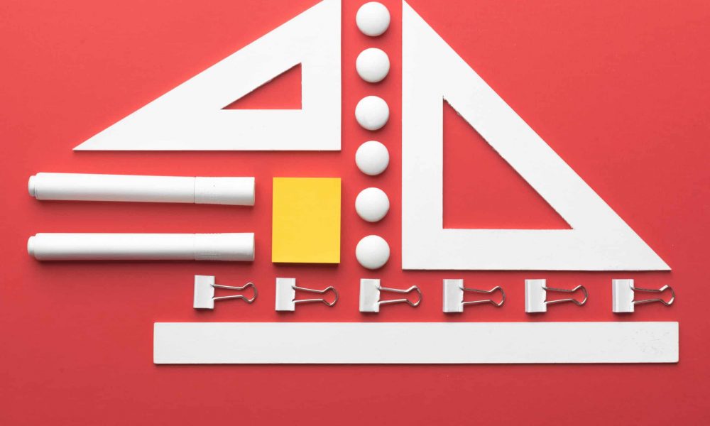 Top view picture of office supplies on the red background table
